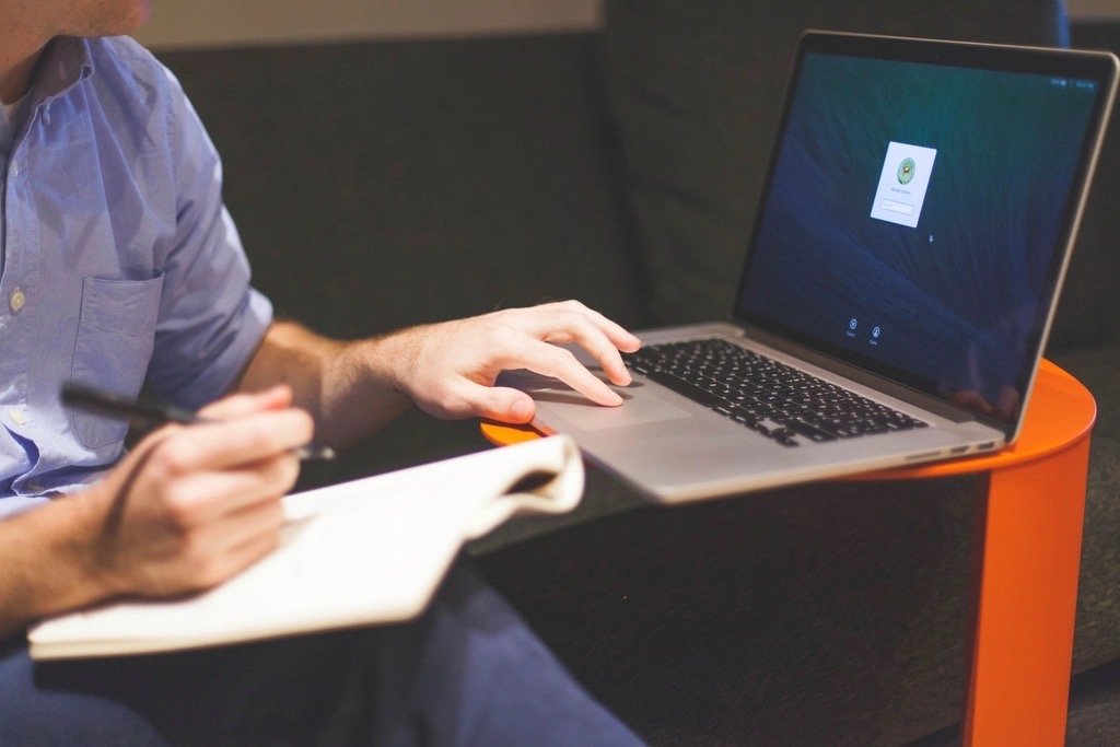 Preparing a written car deal analysis report on a laptop